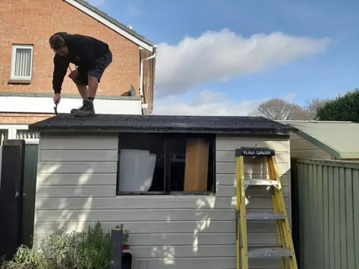 A Repair My Shed specialist repairing a shed roof