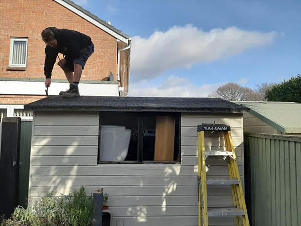 A Repair My Shed specialist repairing a shed roof